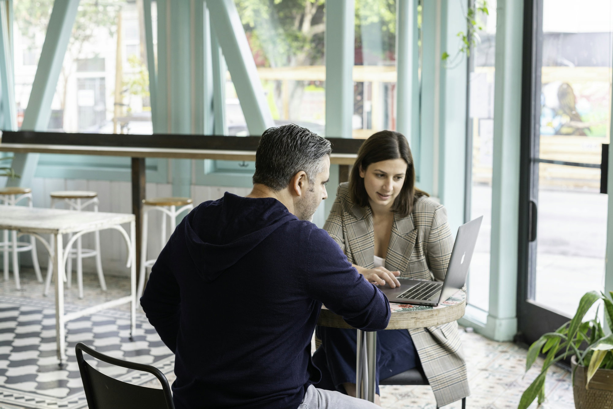 man-in-black-long-sleeve-shirt-sitting-on-chair-beside-woman-in-black-and-white-stripe.jpg man in black long sleeve shirt sitting on chair beside woman in black and white stripe